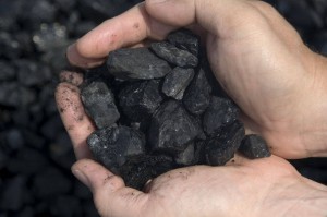 hands holding coal