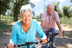 elderly couple riding bikes