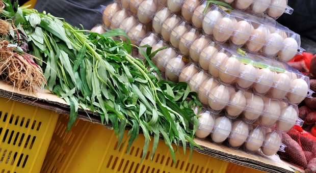 Eggs and herbs on market stand