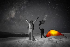 two people smoke signaling in the wilderness