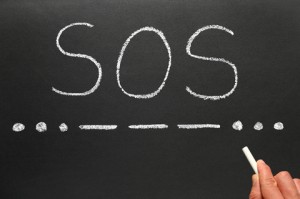 SOS written on a blackboard