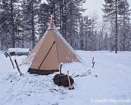 Tent in snow covered forest