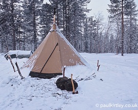 Tent in snow covered forest