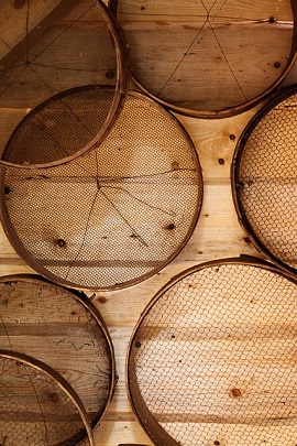 strainers on wood wall