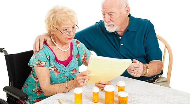 Senior couple go over their medical and prescription drug bills.